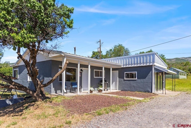21932 2225th Rd, Cedaredge, CO 81413 - ranch-style house featuring stucco siding, a patio, and a metal roof