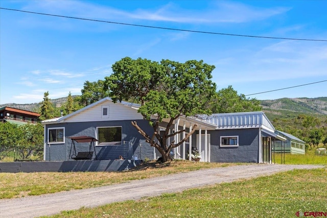 21932 2225th Rd, Cedaredge, CO 81413 - view of front of house with a mountain view, stucco siding, and dirt driveway