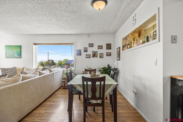 21932 2225th Rd, Cedaredge, CO 81413 - dining area featuring wood finished floors and a textured ceiling