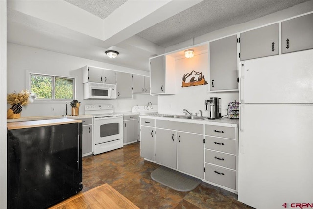 21932 2225th Rd, Cedaredge, CO 81413 - kitchen with white appliances, a textured ceiling, light countertops, and gray cabinets