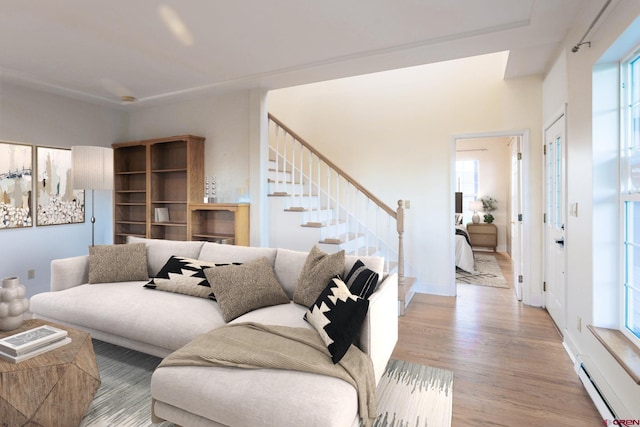 825 County Road 17, Gunnison, CO 81230 - living room with a baseboard heating unit, stairway, and wood finished floors
