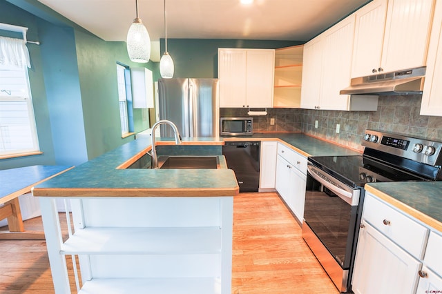 825 County Road 17, Gunnison, CO 81230 - kitchen featuring stainless steel appliances, under cabinet range hood, open shelves, a center island with sink, and tasteful backsplash