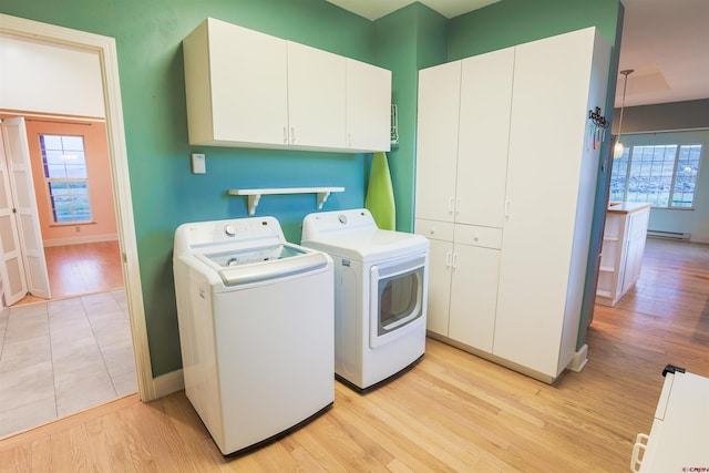 825 County Road 17, Gunnison, CO 81230 - laundry room featuring cabinet space, washing machine and clothes dryer, and light wood finished floors