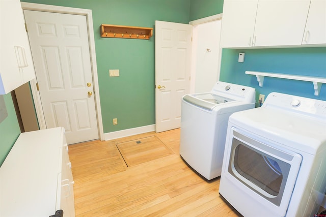 825 County Road 17, Gunnison, CO 81230 - laundry area featuring washer and dryer, cabinet space, and light wood-type flooring
