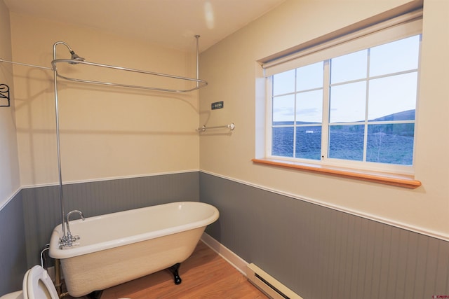 825 County Road 17, Gunnison, CO 81230 - bathroom with a wainscoted wall, a freestanding bath, wood finished floors, and a water view