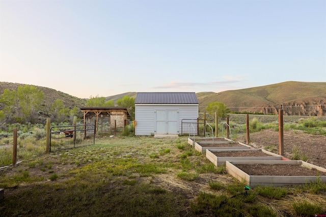 825 County Road 17, Gunnison, CO 81230 - view of yard featuring a vegetable garden, a shed, and a mountain view