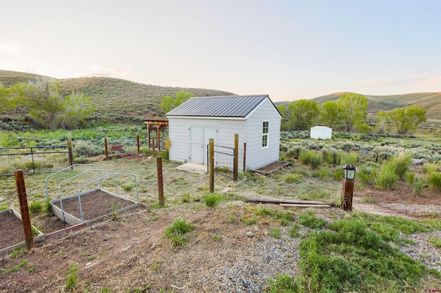 825 County Road 17, Gunnison, CO 81230 - view of yard featuring a vegetable garden, a shed, and a mountain view