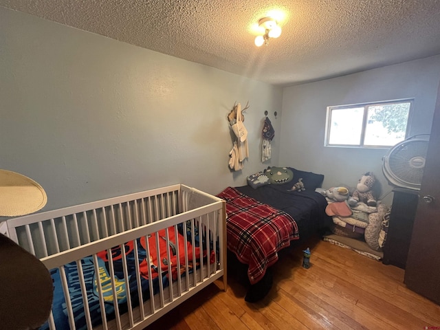 537 N Colorado Ave, Dove Creek, CO 81324 - bedroom with hardwood / wood-style flooring and a textured ceiling