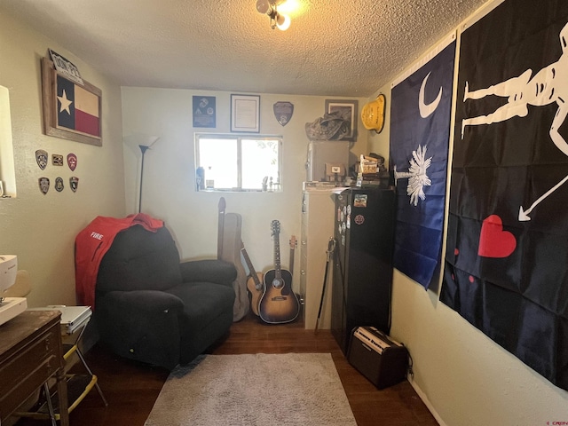 537 N Colorado Ave, Dove Creek, CO 81324 - living area featuring wood finished floors and a textured ceiling
