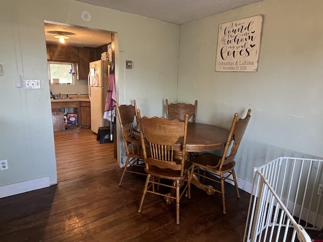537 N Colorado Ave, Dove Creek, CO 81324 - dining space with dark wood-style flooring and a textured ceiling