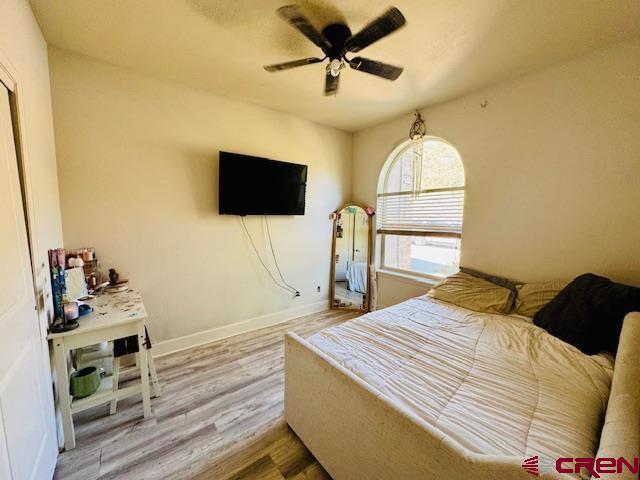 1490 SE Fairway Dr, Cedaredge, CO 81413 - bedroom with wood finished floors and ceiling fan