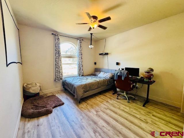 1490 SE Fairway Dr, Cedaredge, CO 81413 - bedroom featuring wood finished floors and ceiling fan