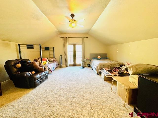 1490 SE Fairway Dr, Cedaredge, CO 81413 - bedroom with vaulted ceiling, carpet flooring, and ceiling fan