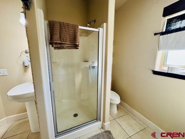 1490 SE Fairway Dr, Cedaredge, CO 81413 - bathroom with tile patterned flooring and a shower stall