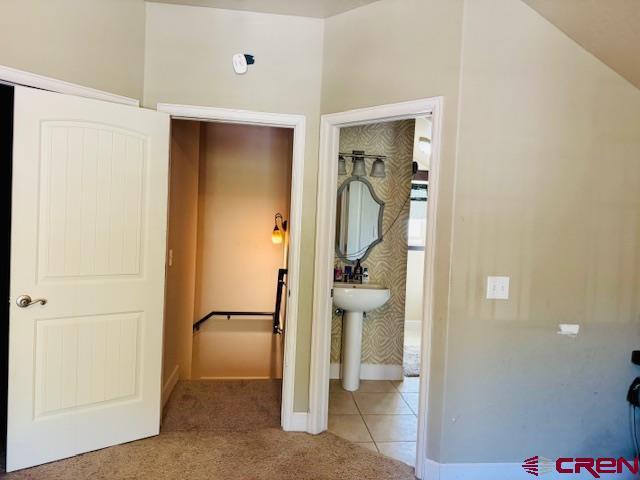 1490 SE Fairway Dr, Cedaredge, CO 81413 - unfurnished bedroom featuring carpet flooring and tile patterned flooring