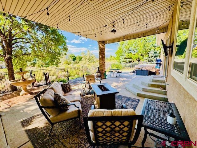 1490 SE Fairway Dr, Cedaredge, CO 81413 - view of patio with an outdoor living space with a fire pit