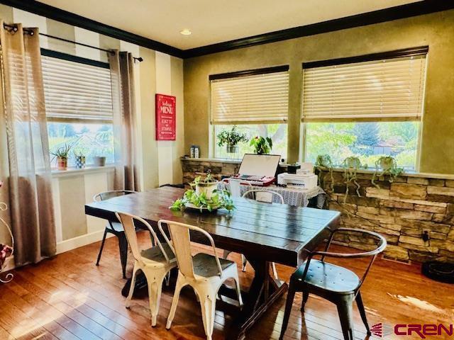 1490 SE Fairway Dr, Cedaredge, CO 81413 - dining area with hardwood / wood-style flooring and crown molding