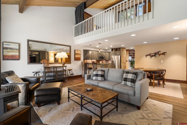 73 S Tamarron Dr Unit 822, Durango, CO 81301 - living room featuring light wood-type flooring, a high ceiling, recessed lighting, and beamed ceiling