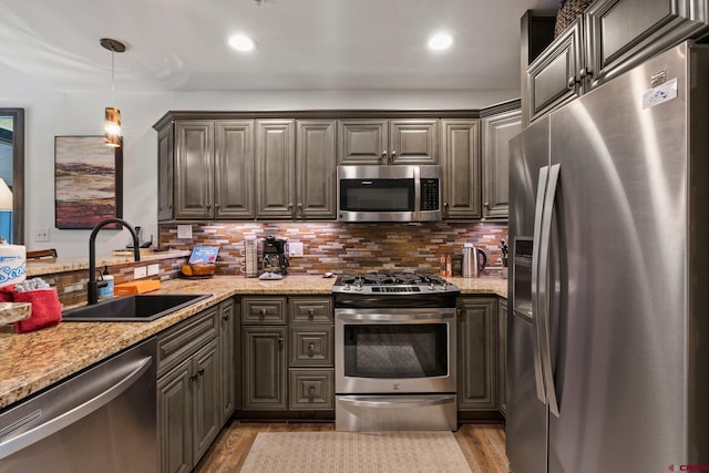 73 S Tamarron Dr Unit 822, Durango, CO 81301 - kitchen featuring appliances with stainless steel finishes, backsplash, light stone counters, and recessed lighting