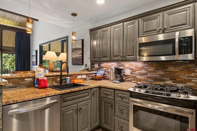 73 S Tamarron Dr Unit 822, Durango, CO 81301 - kitchen with stainless steel appliances, backsplash, hanging light fixtures, and light stone counters