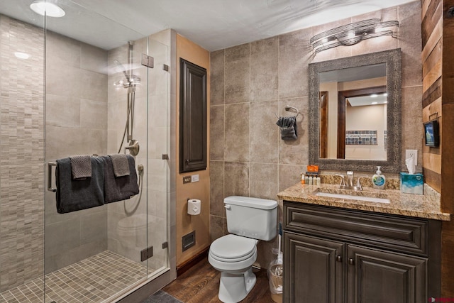 73 S Tamarron Dr Unit 822, Durango, CO 81301 - full bathroom with wood finished floors, vanity, tile walls, and a stall shower