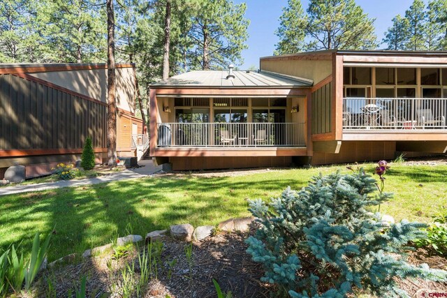 73 S Tamarron Dr Unit 822, Durango, CO 81301 - back of house with a yard, a standing seam roof, and a metal roof