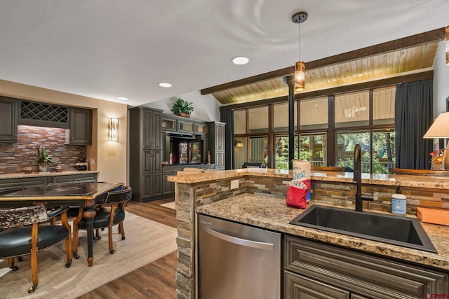 73 S Tamarron Dr Unit 822, Durango, CO 81301 - kitchen featuring stainless steel dishwasher, dark wood-style flooring, tasteful backsplash, light stone counters, and recessed lighting