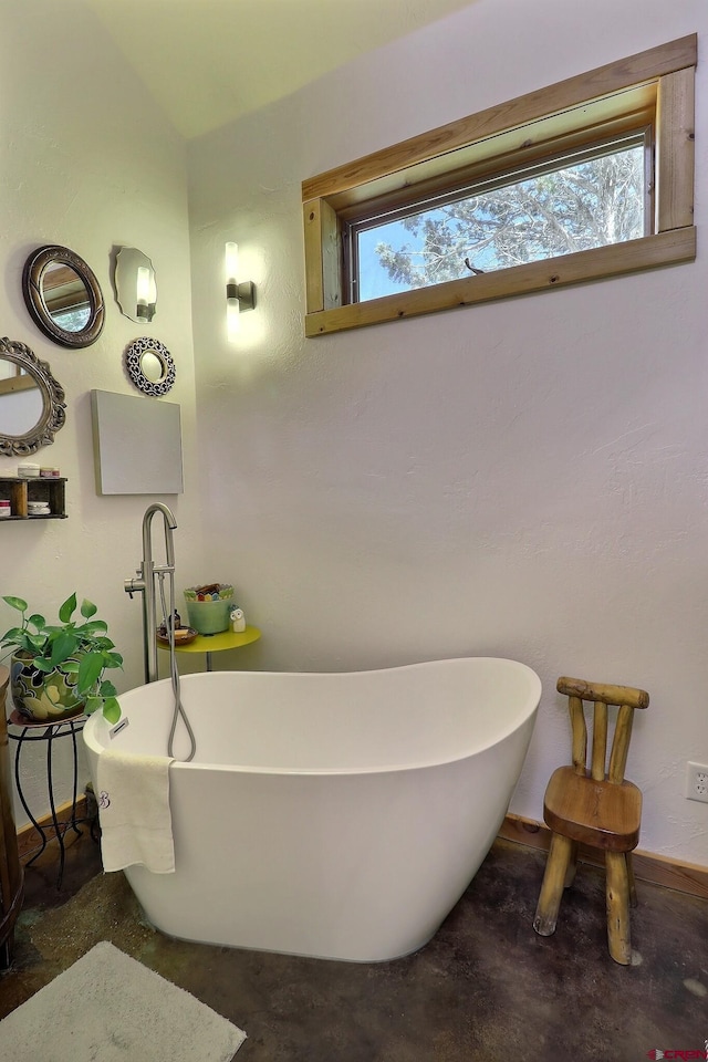 16242 Farmers Mine Rd, Paonia, CO 81428 - bathroom featuring a freestanding bath, plenty of natural light, and concrete floors