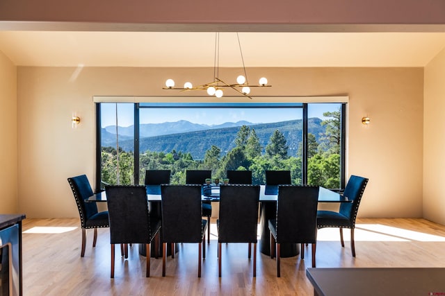 570 Jenkins Ranch Rd, Durango, CO 81301 - dining area featuring a chandelier, a mountain view, healthy amount of natural light, and wood finished floors