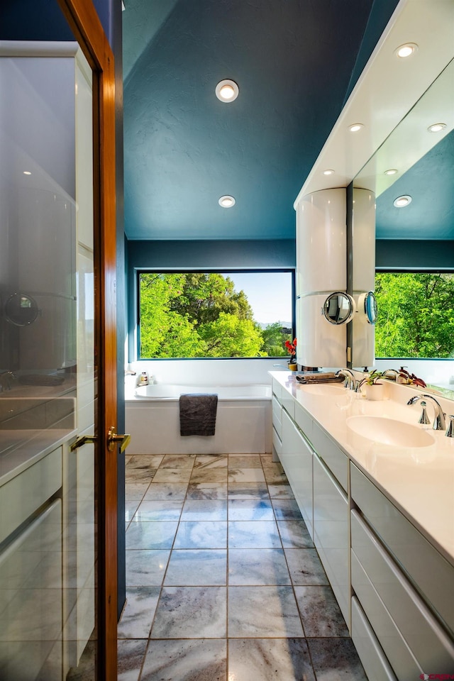 570 Jenkins Ranch Rd, Durango, CO 81301 - bathroom featuring double vanity, a garden tub, and recessed lighting