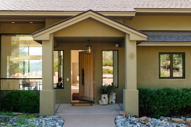 570 Jenkins Ranch Rd, Durango, CO 81301 - property entrance featuring stucco siding, roof with shingles, and a surveillance system