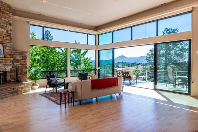 570 Jenkins Ranch Rd, Durango, CO 81301 - living room featuring a mountain view, wood finished floors, a fireplace, recessed lighting, and a towering ceiling