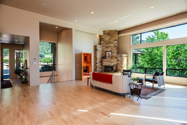 570 Jenkins Ranch Rd, Durango, CO 81301 - living room with healthy amount of natural light, a stone fireplace, wood finished floors, and recessed lighting