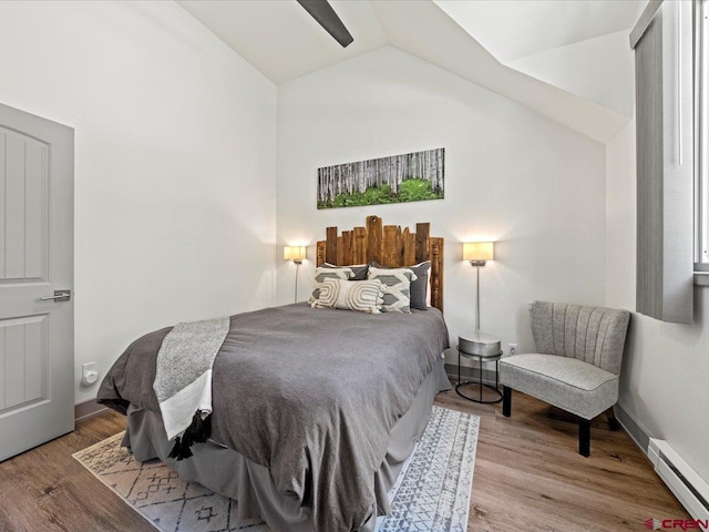 1254 Champ Ln, Ouray, CO 81427 - bedroom with baseboard heating, vaulted ceiling, and wood finished floors