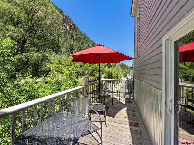 1254 Champ Ln, Ouray, CO 81427 - deck featuring outdoor dining area and a view of trees