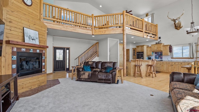 61850 V62 Trl, Montrose, CO 81403 - living room with a towering ceiling, stairway, a glass covered fireplace, light carpet, and recessed lighting