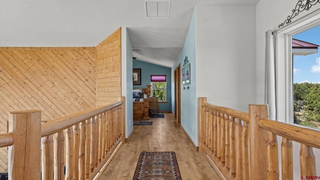 61850 V62 Trl, Montrose, CO 81403 - corridor with an upstairs landing, vaulted ceiling, light wood-style floors, and wooden walls