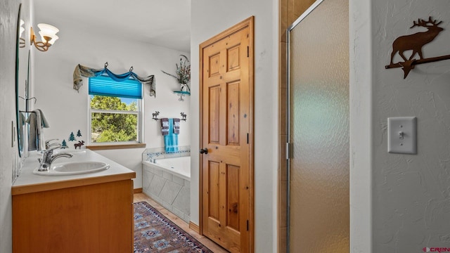 61850 V62 Trl, Montrose, CO 81403 - bathroom featuring a bath, a stall shower, and double vanity