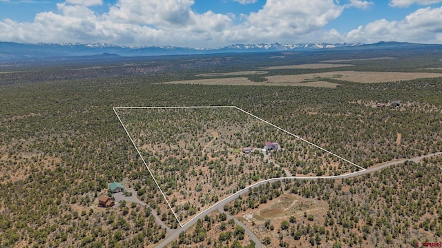 61850 V62 Trl, Montrose, CO 81403 - aerial view of sparsely populated area with property boundaries highlighted and a mountainous background