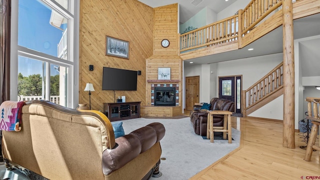 61850 V62 Trl, Montrose, CO 81403 - living room with a towering ceiling, plenty of natural light, wood finished floors, stairs, and wood walls