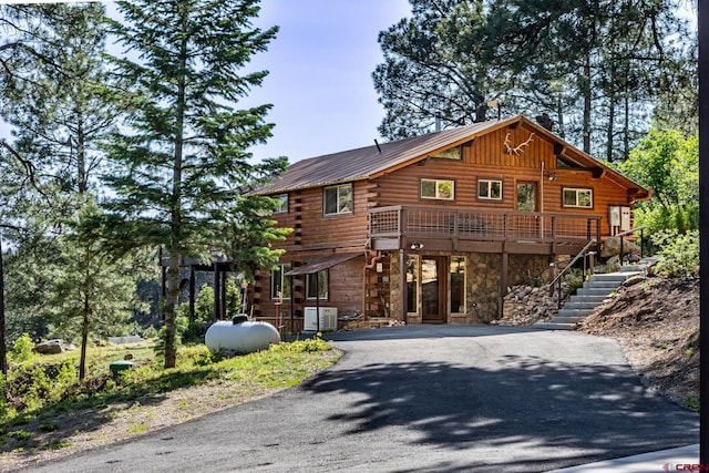 9 Los Ranchitos Dr, Durango, CO 81301 - cabin featuring log siding, asphalt driveway, stone siding, stairs, and a deck