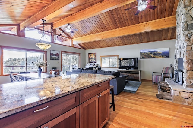 9 Los Ranchitos Dr, Durango, CO 81301 - kitchen with a ceiling fan, light wood-style flooring, hanging light fixtures, light stone countertops, and open floor plan