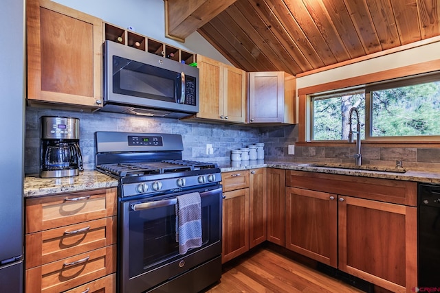 9 Los Ranchitos Dr, Durango, CO 81301 - kitchen with gas range, stainless steel microwave, black dishwasher, tasteful backsplash, and light stone counters