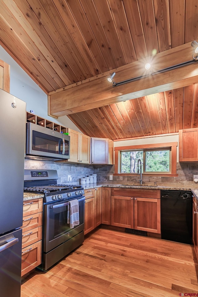 9 Los Ranchitos Dr, Durango, CO 81301 - kitchen with appliances with stainless steel finishes, tasteful backsplash, light stone counters, wooden ceiling, and light wood-type flooring