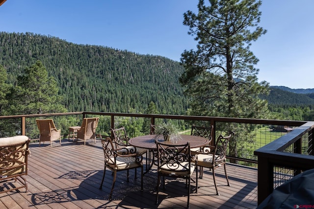 9 Los Ranchitos Dr, Durango, CO 81301 - deck featuring a wooded view, a mountain view, and outdoor dining space