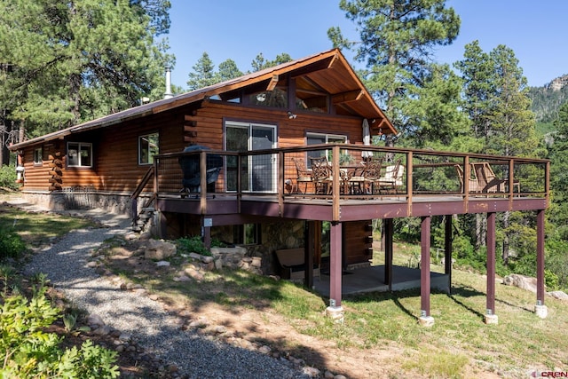 9 Los Ranchitos Dr, Durango, CO 81301 - back of property with a deck, log siding, stairs, and a patio