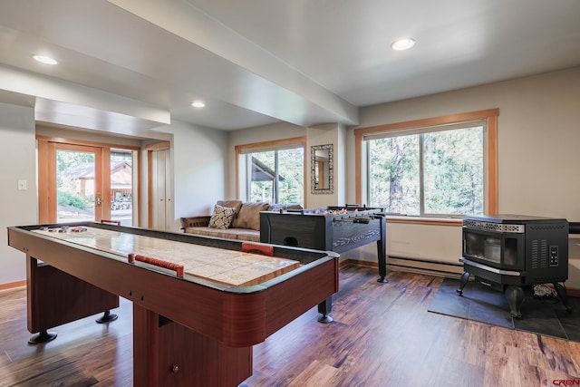9 Los Ranchitos Dr, Durango, CO 81301 - playroom featuring wood finished floors, french doors, a wood stove, recessed lighting, and a baseboard heating unit