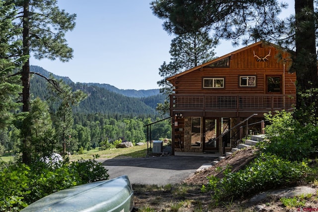 9 Los Ranchitos Dr, Durango, CO 81301 - rear view of house featuring a view of trees, board and batten siding, log siding, stairway, and a deck with mountain view