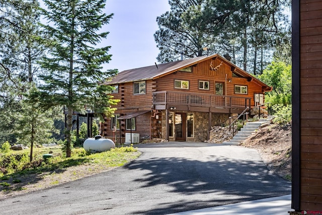 9 Los Ranchitos Dr, Durango, CO 81301 - log home featuring log exterior, driveway, stone siding, stairs, and a deck