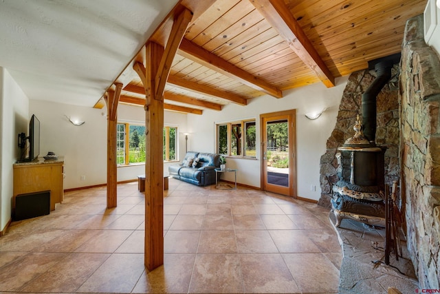 2415 Echo Canyon Ranch Ln, Pagosa Springs, CO 81147 - living area featuring a wood stove, light tile patterned floors, and a wooden ceiling with exposed beams